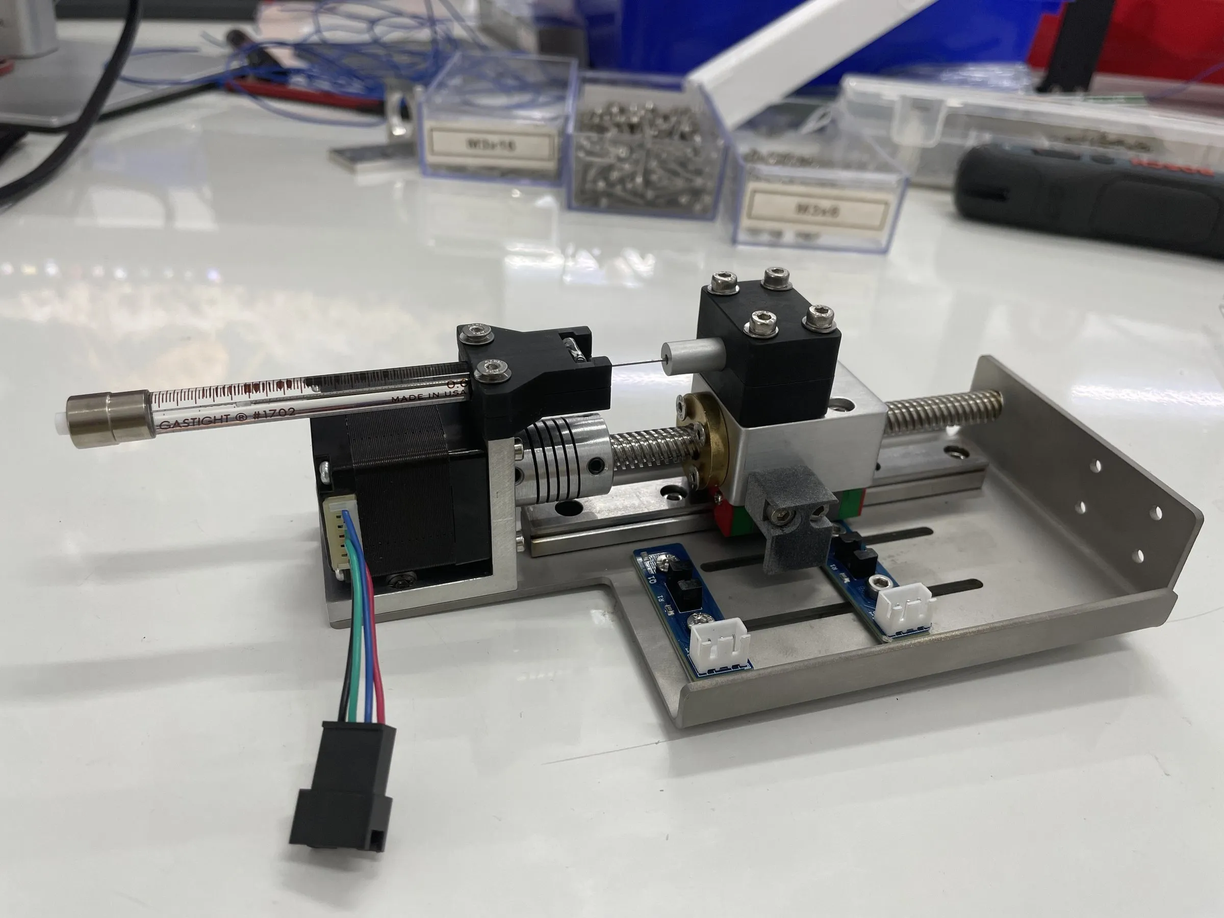 A syringe mounted on a stepper-driven lead-screw stage