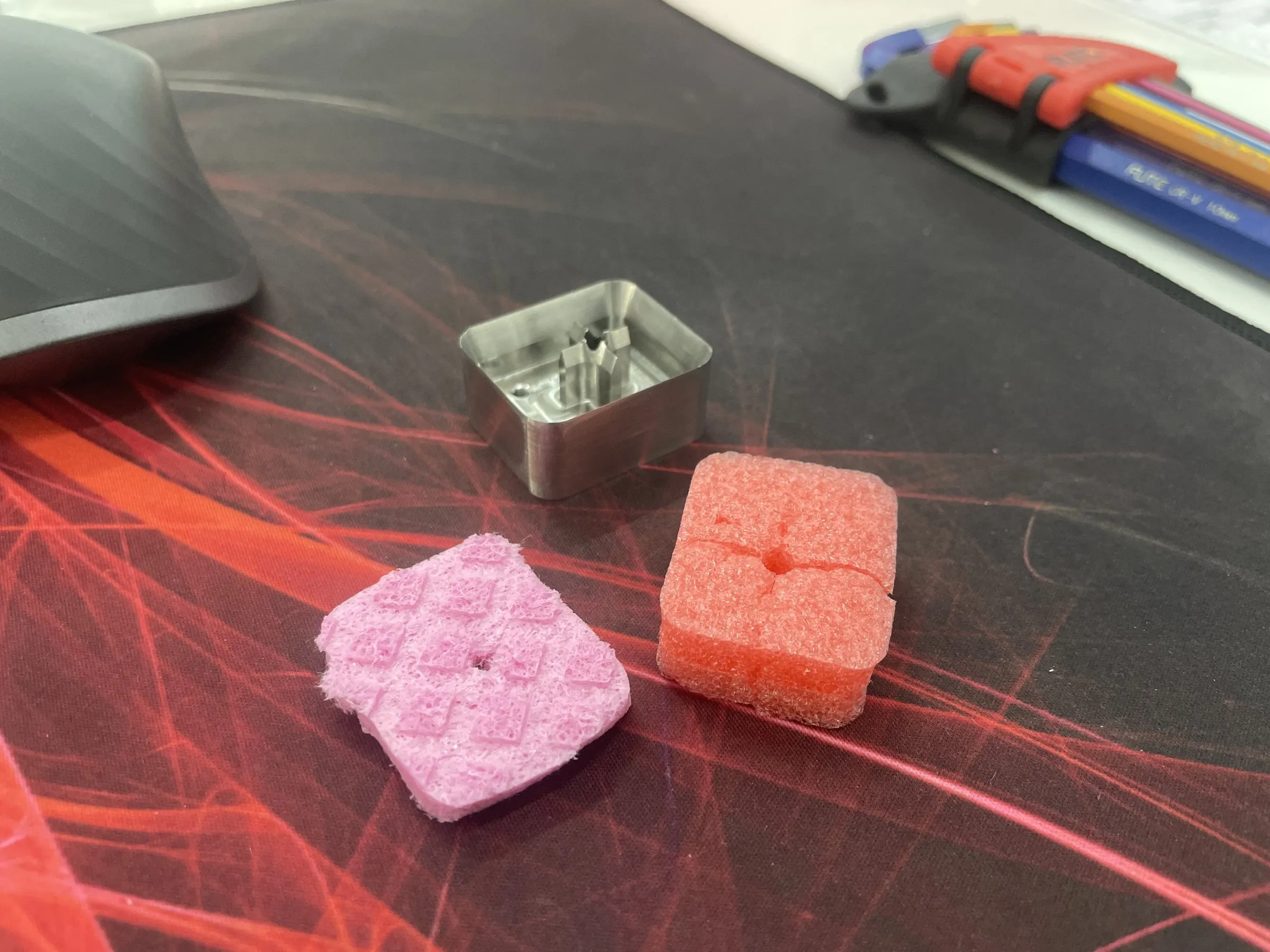 A small machined aluminum housing on a desk