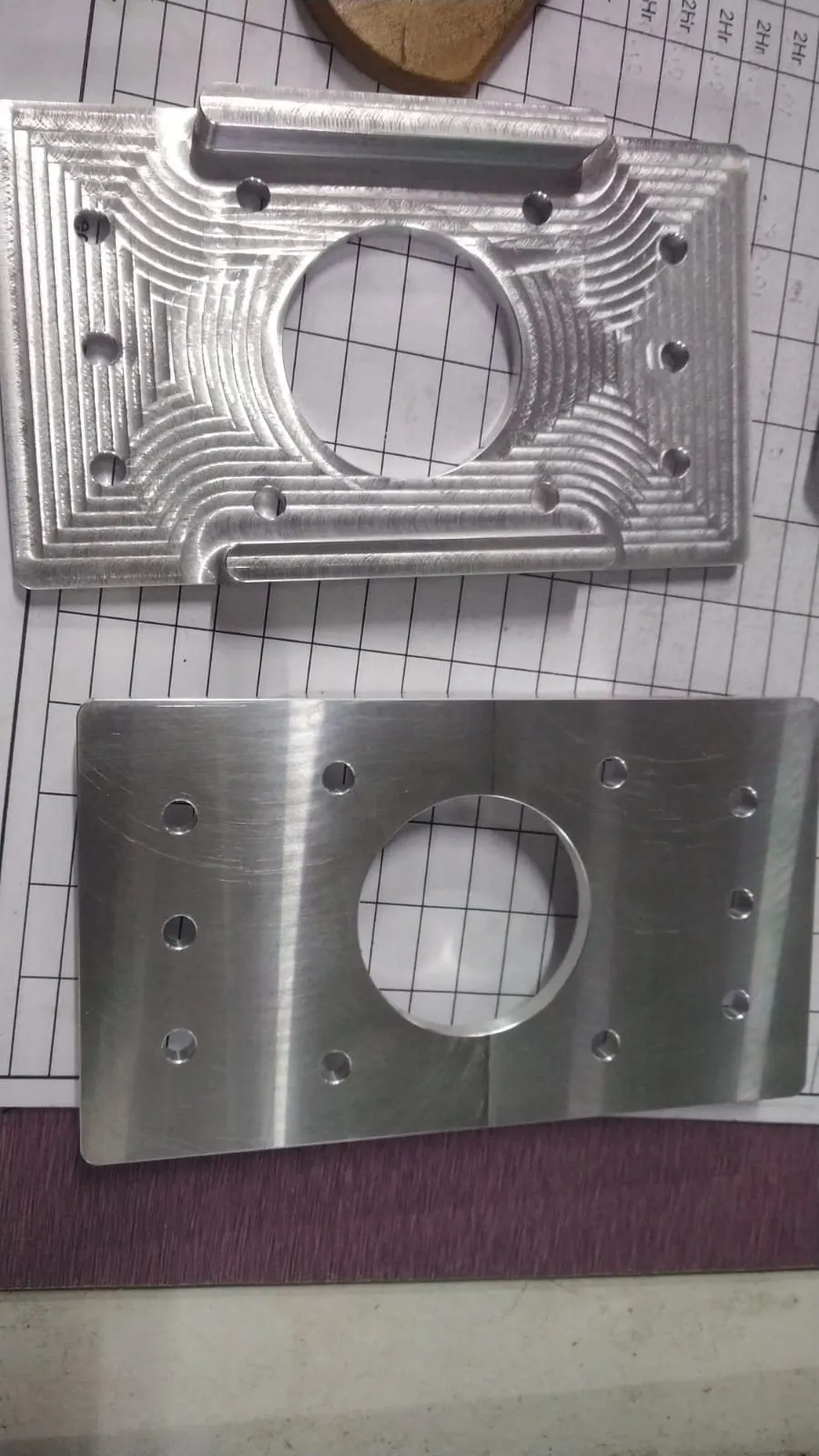 Two machined plates with large bored openings