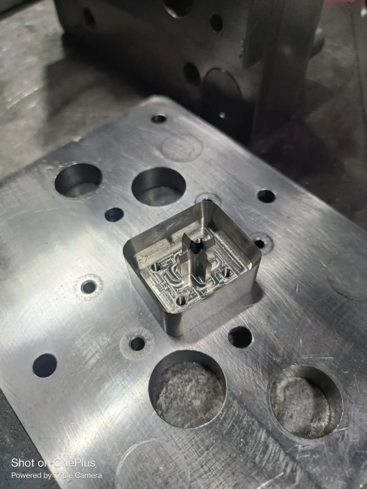 Machined aluminum plate with pockets and bored holes