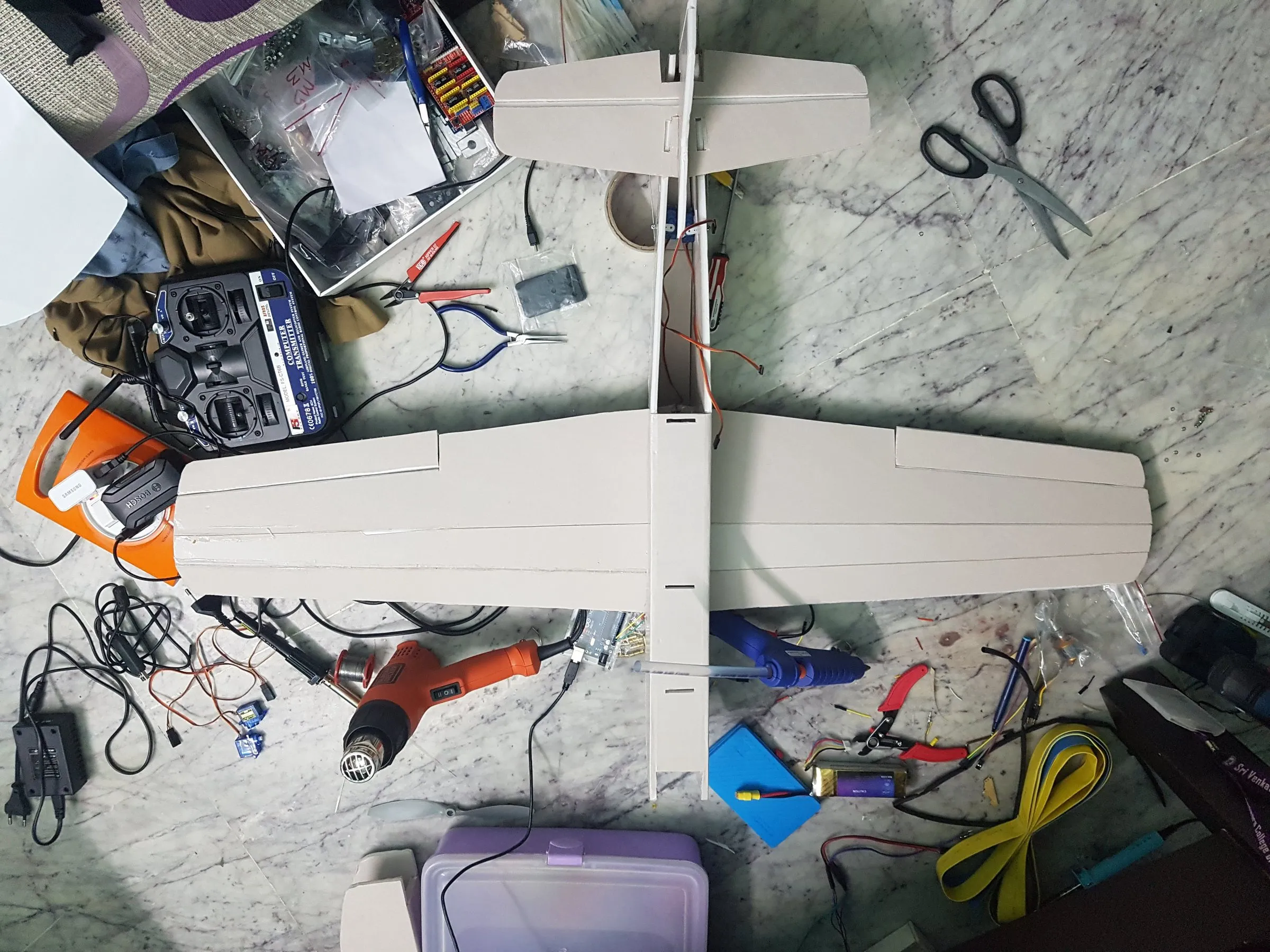 An RC plane under construction on a workbench