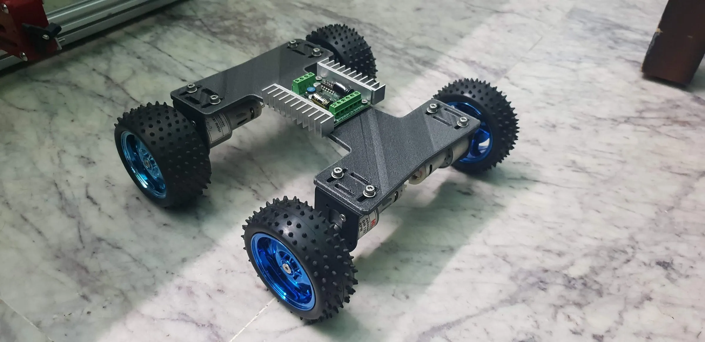 A four-wheel rover chassis with blue wheels