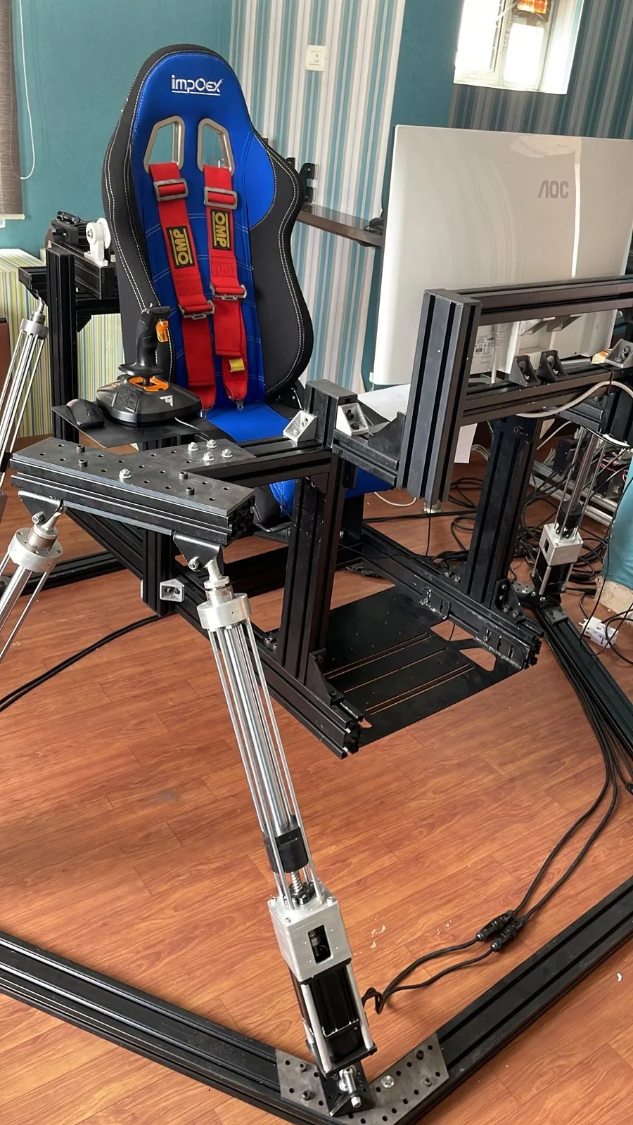Racing seat mounted on linear actuators