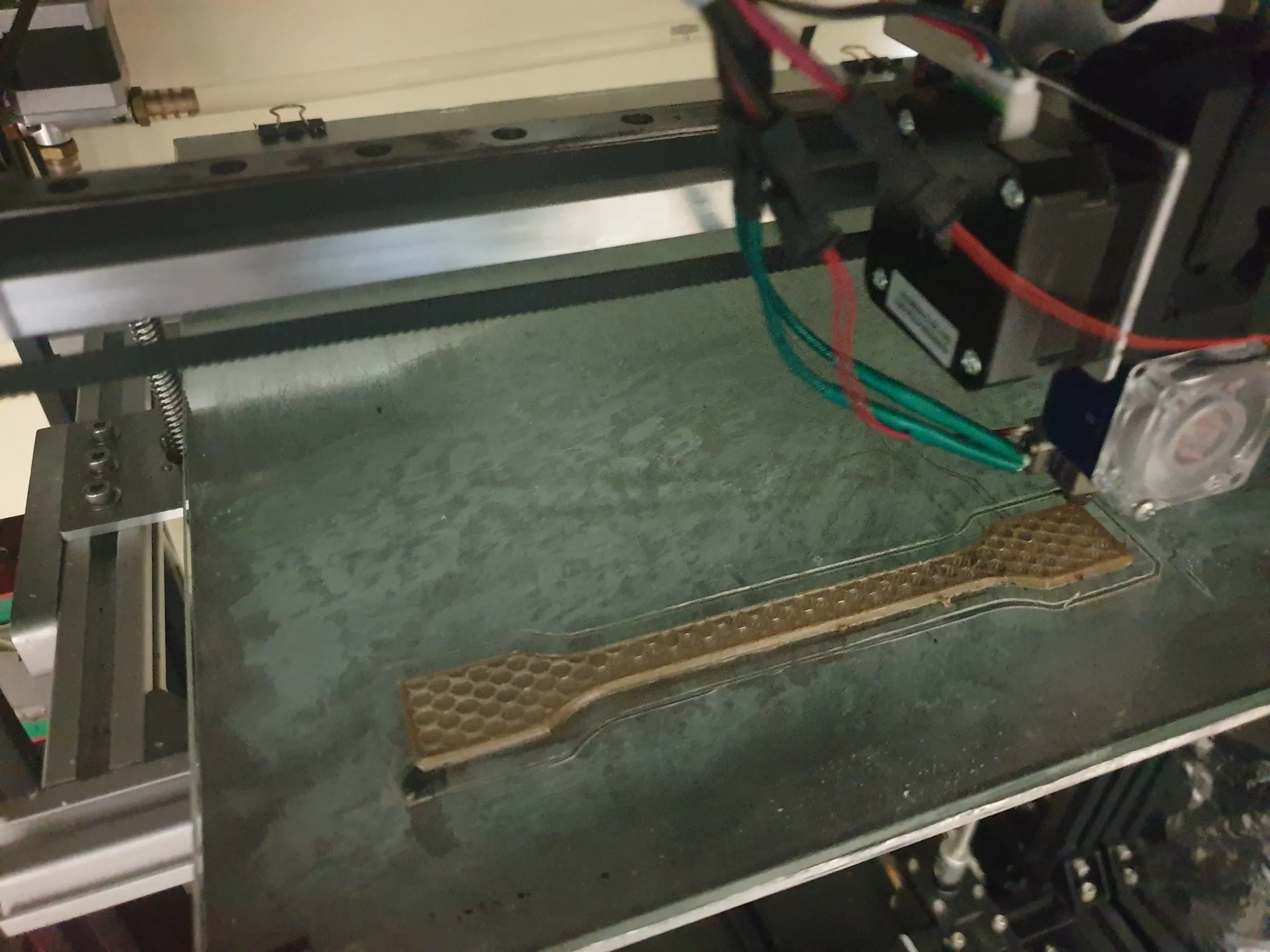 A PEEK dog-bone specimen being printed
