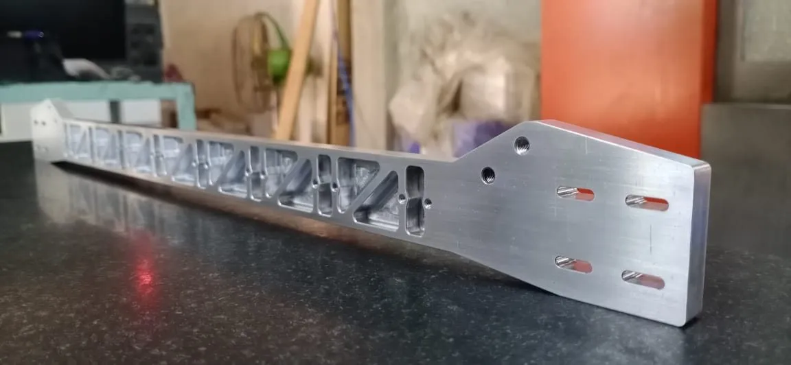 A long machined aluminum arm with a triangulated truss pattern